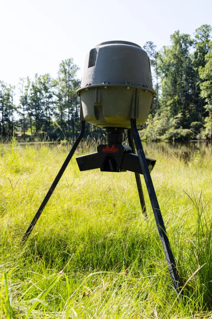 NiteVault game feeder in tall grass.